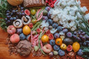 Colorful spread of fruits, grains, and flowers