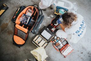 First-aid and gear kit spread on the ground