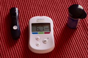 Blood glucose meter reading beside test supplies