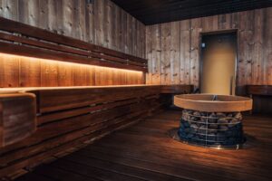 Wood-lined sauna with a stone heater