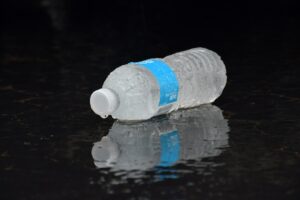 Plastic water bottle floating on dark water