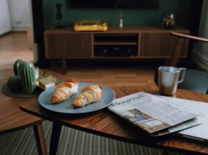 Croissants and newspaper on a living-room table