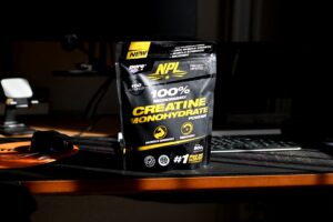 Black creatine supplement bag on a desk