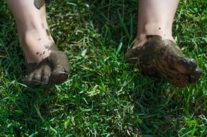Bare Feet Covered in Mud