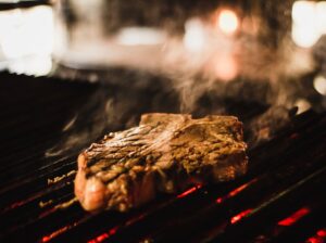 Grilled Steak Cooking Over Open Flame