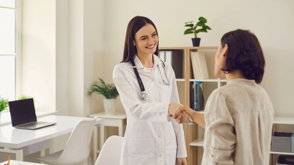 Doctor greeting a patient in a bright office