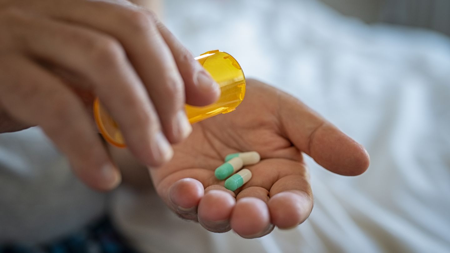  Person Holding Prescription Medication In Hand 
