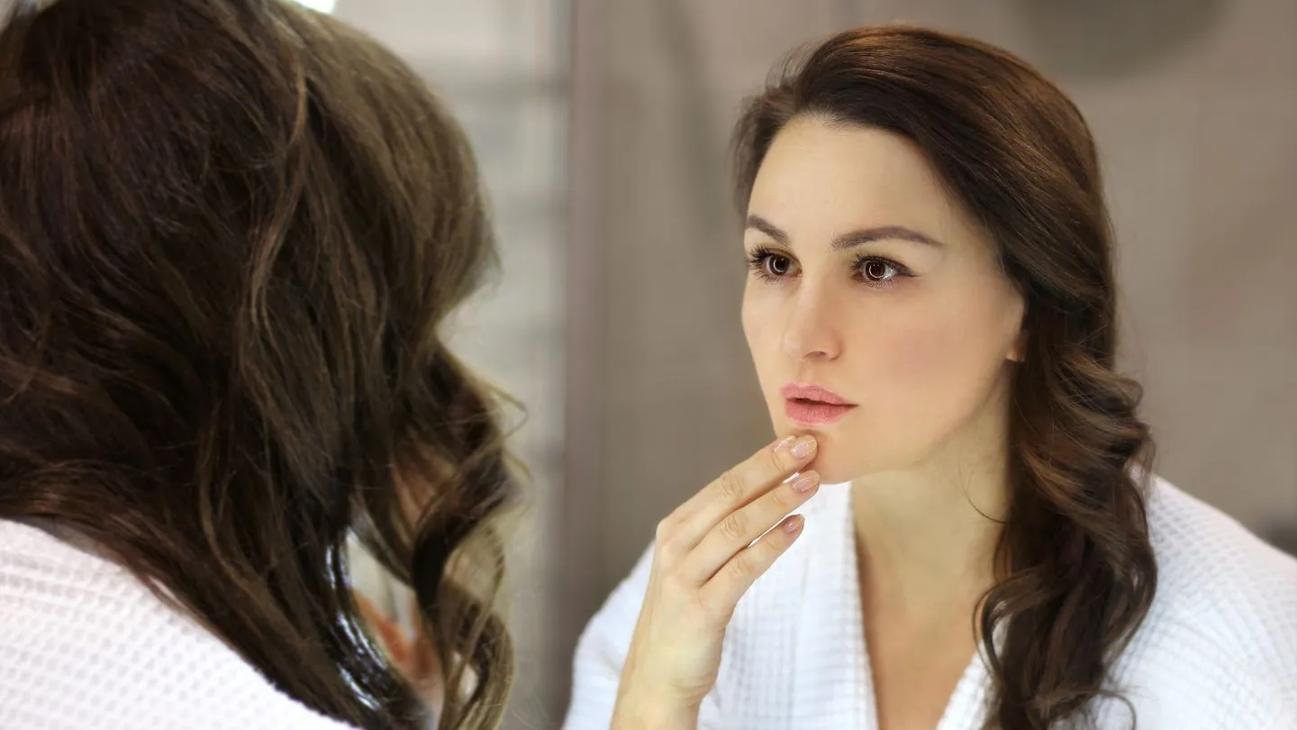  Woman In A Bathrobe Looking At Her Reflection In The Mirror 