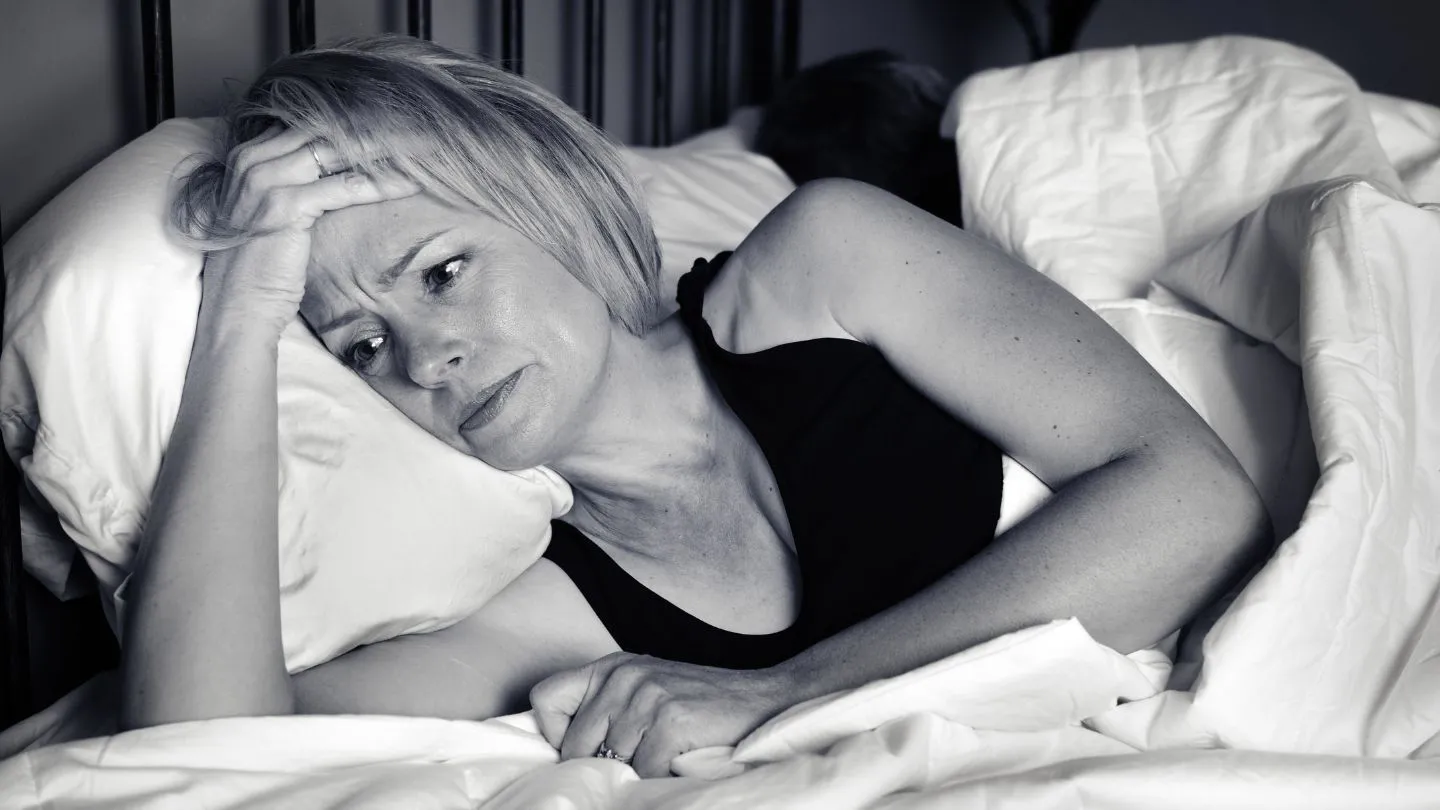 Woman Lying Awake In Bed At Night